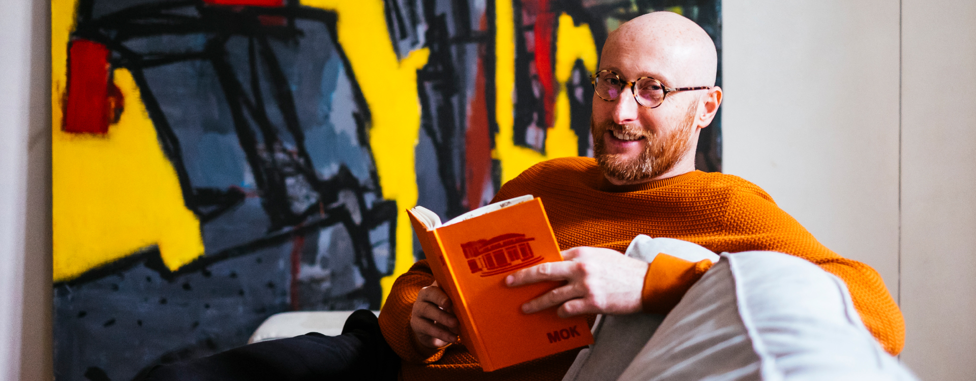 man reading on a couch